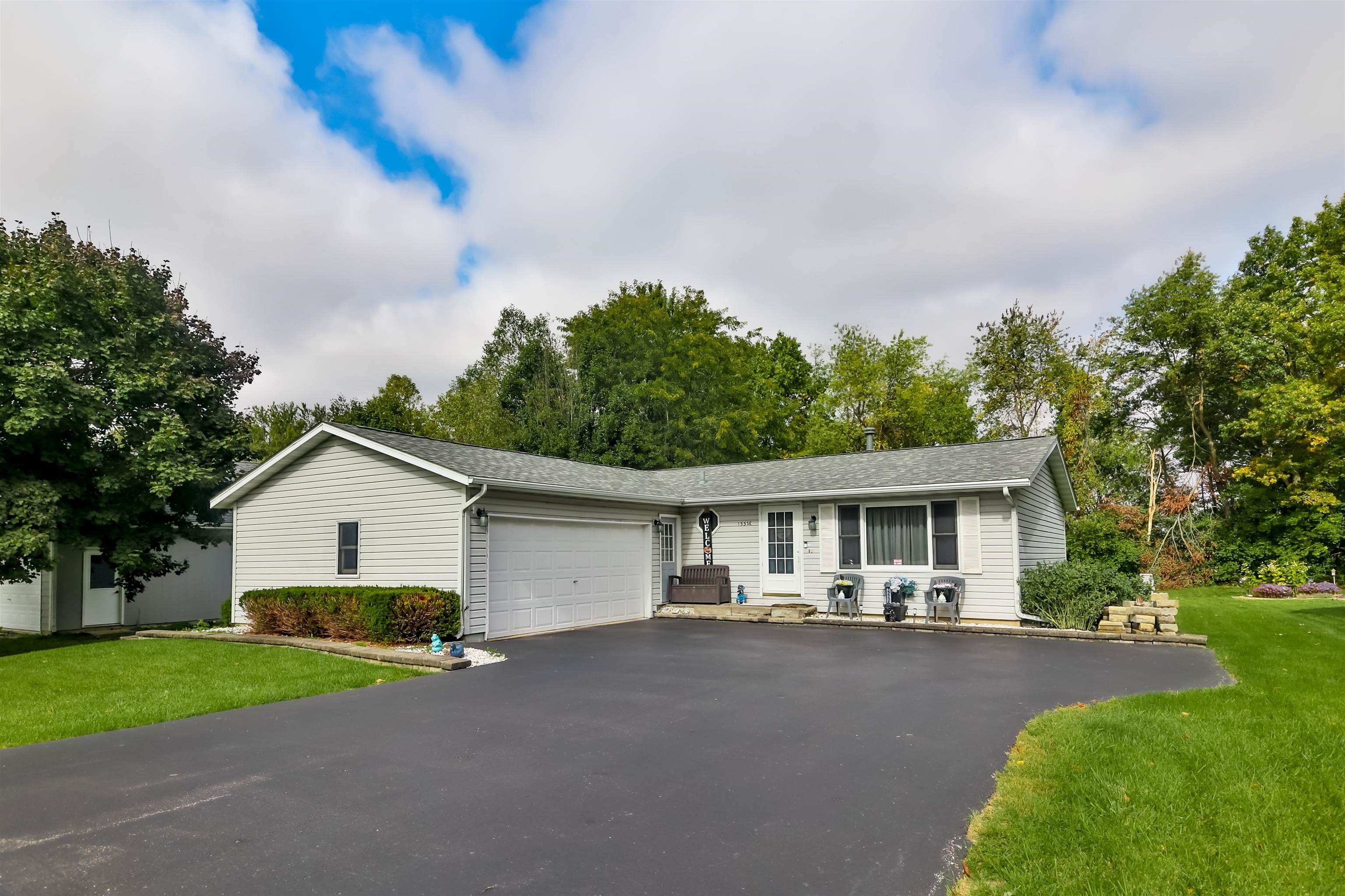 155 Lamplighter Loop Southeast Poplar Grove, IL 61065 - Photo 1 of 31 a view of a house with a yard and large trees