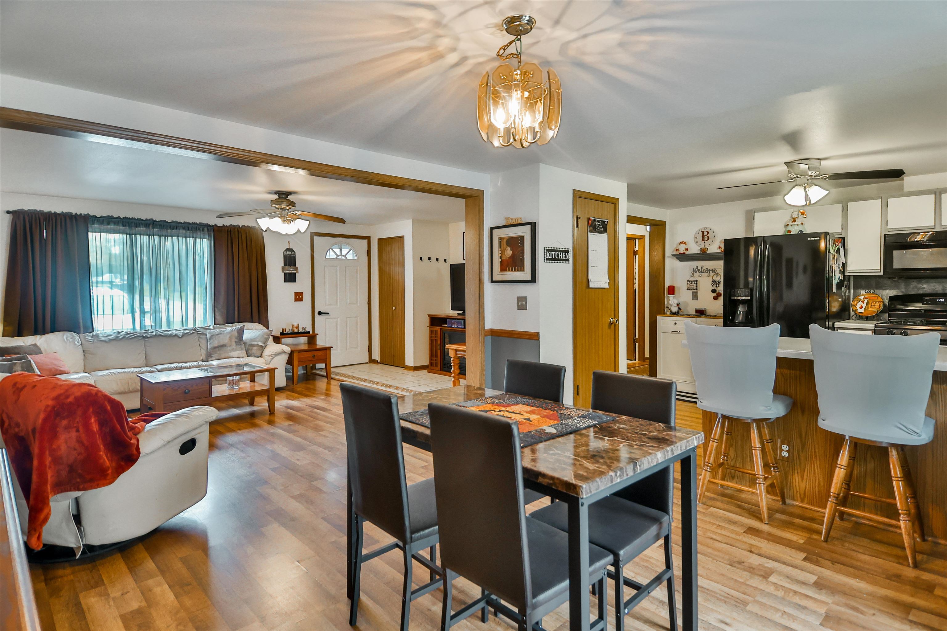 155 Lamplighter Loop Southeast Poplar Grove, IL 61065 - Photo 11 of 31 a view of a dining room with furniture and wooden floor
