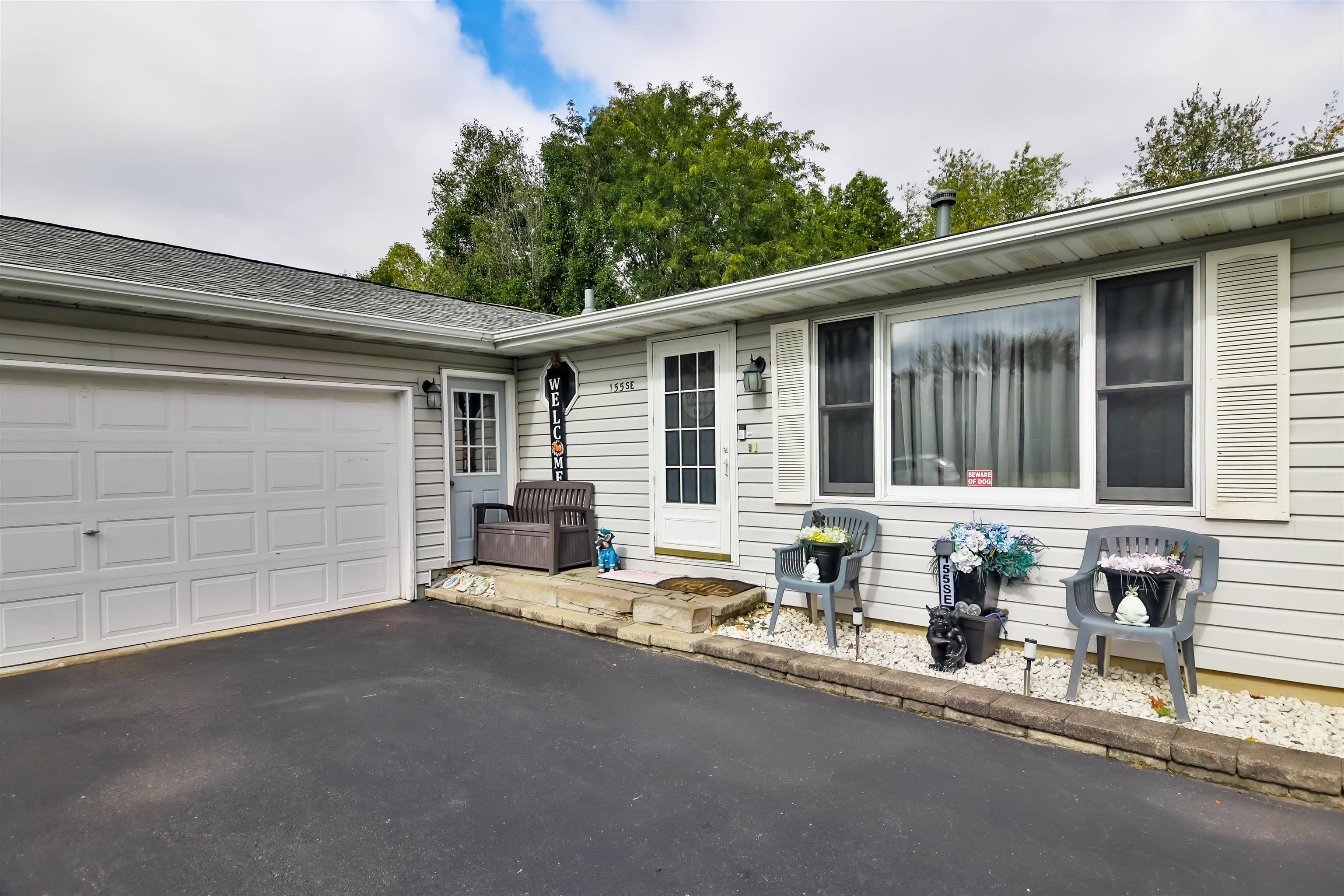 155 Lamplighter Loop Southeast Poplar Grove, IL 61065 - Photo 2 of 31 a front view of a house with outdoor seating and a potted plant