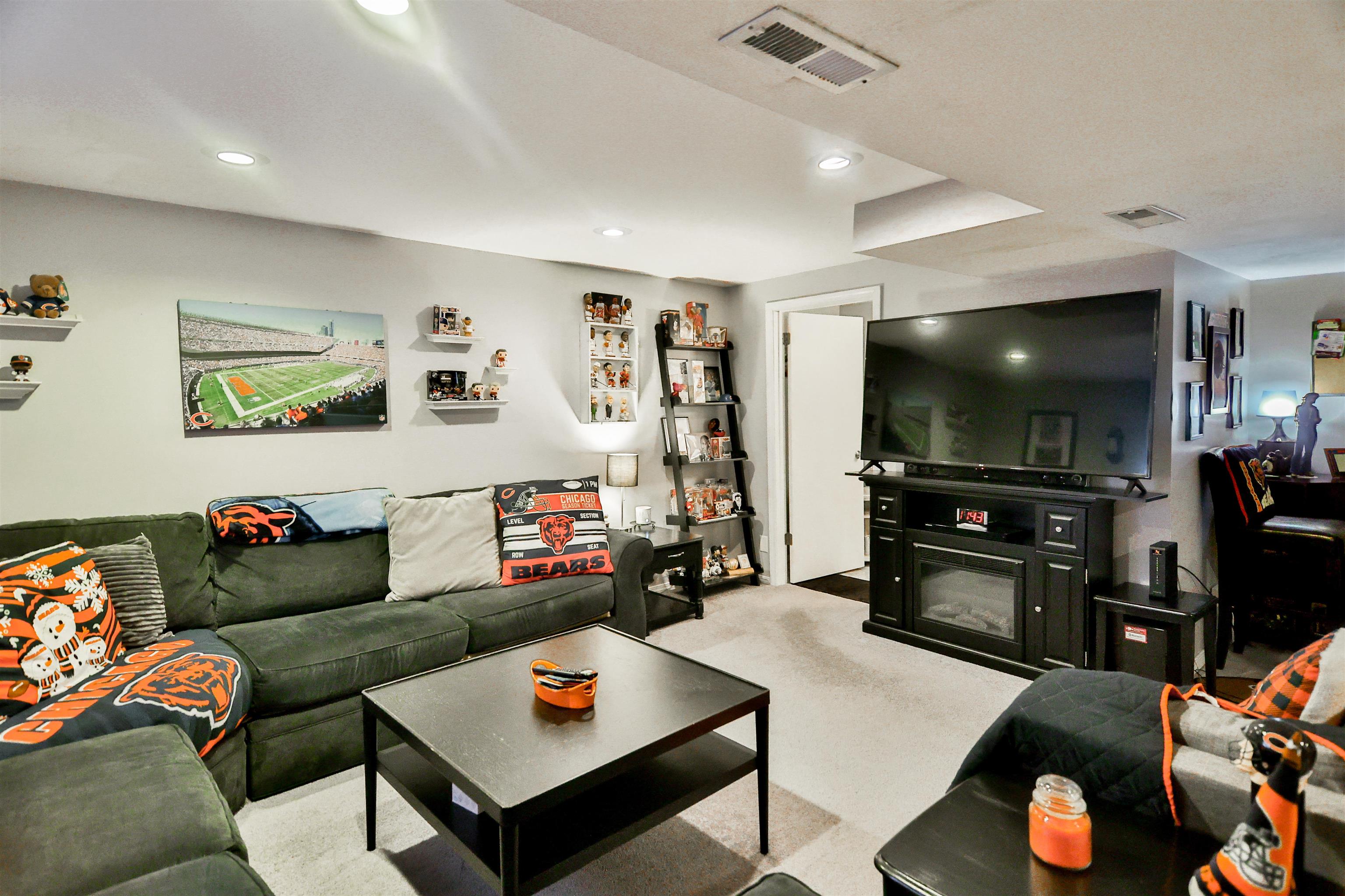 155 Lamplighter Loop Southeast Poplar Grove, IL 61065 - Photo 23 of 31 a living room with furniture and a flat screen tv