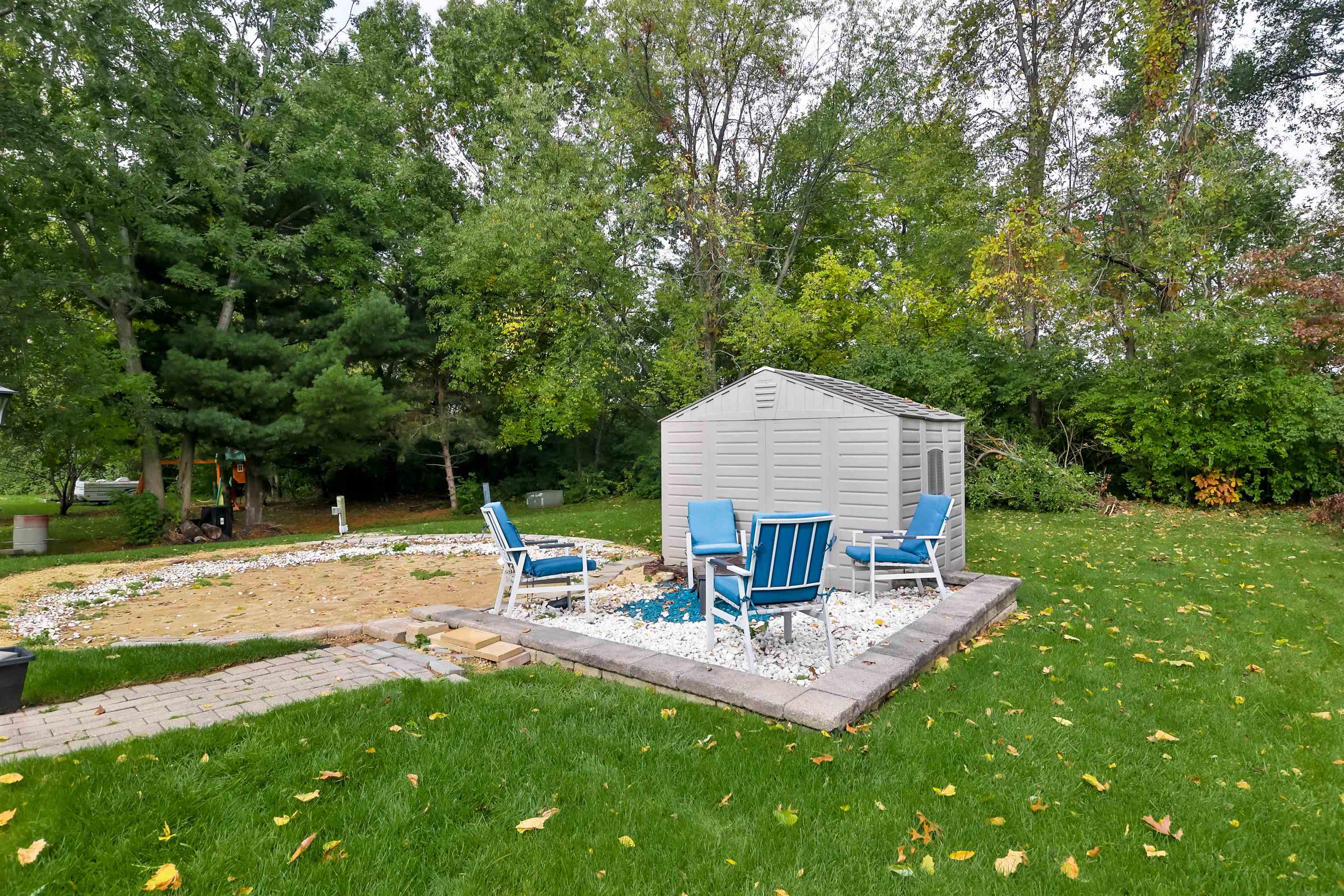 155 Lamplighter Loop Southeast Poplar Grove, IL 61065 - Photo 28 of 31 a view of a patio with couches and a table and chairs with wooden fence