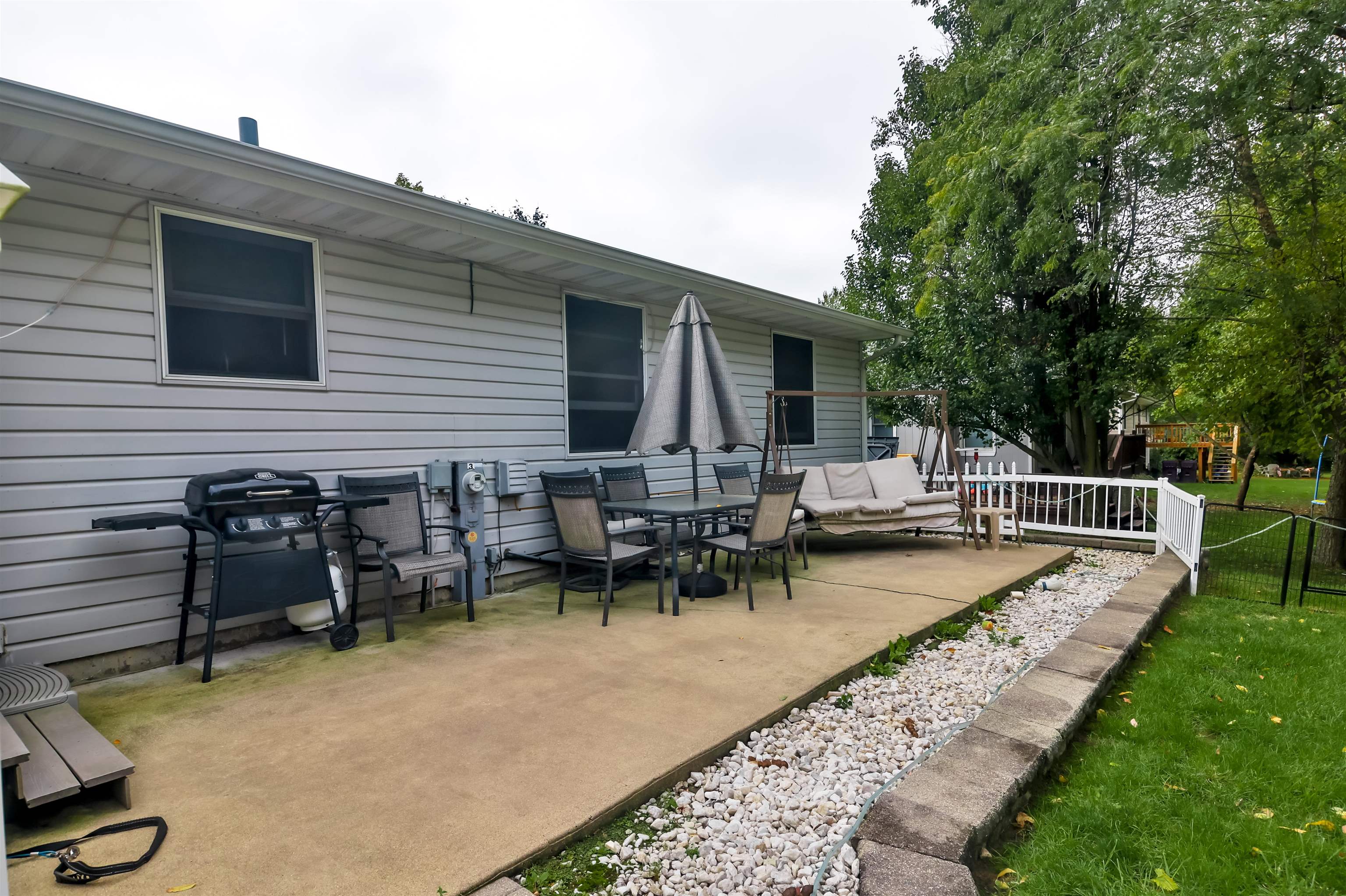 155 Lamplighter Loop Southeast Poplar Grove, IL 61065 - Photo 31 of 31 a view of a house with patio and a garden