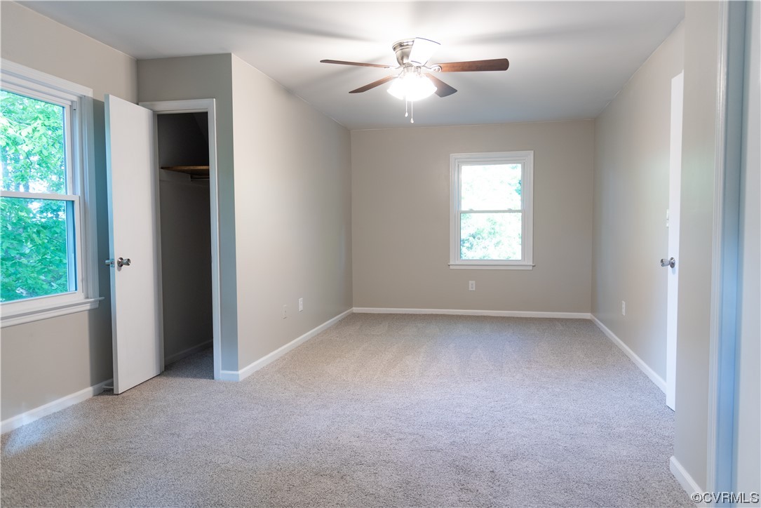 10807 Drayton Road Chester, VA 23831 - Photo 23 of 32 an empty room with a window and a ceiling fan