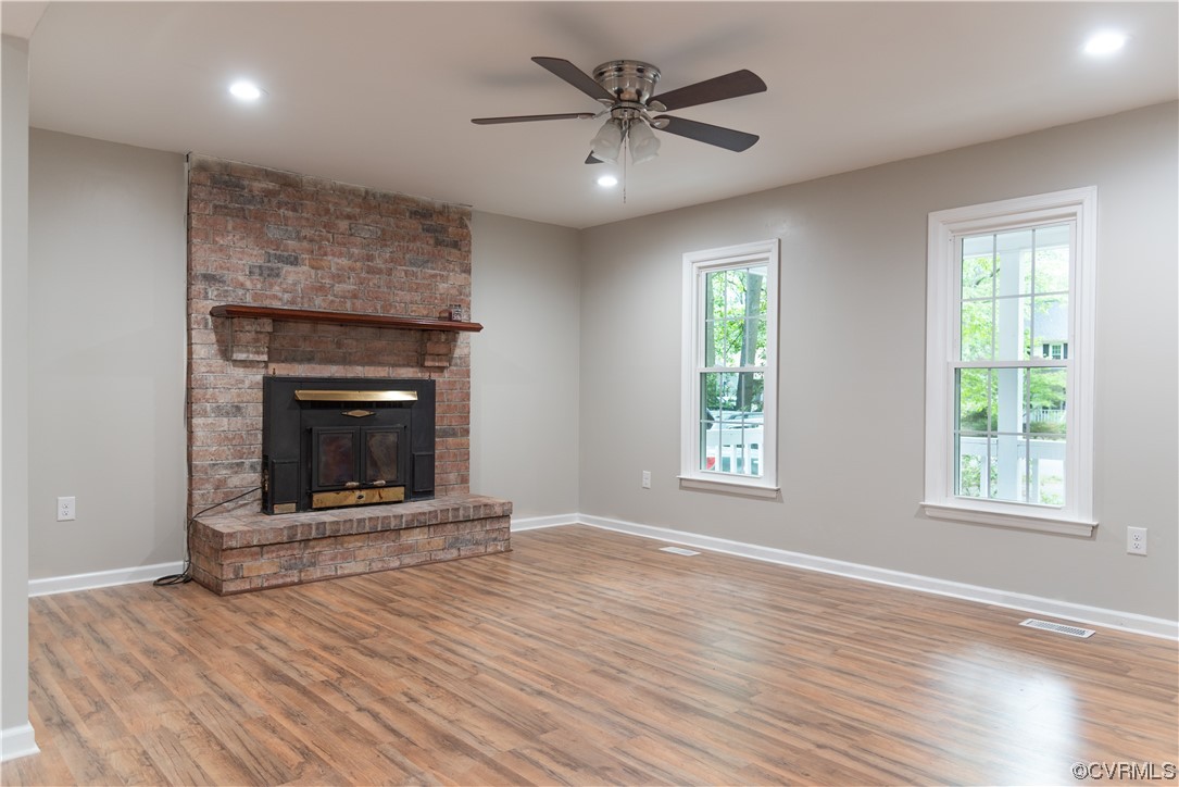10807 Drayton Road Chester, VA 23831 - Photo 5 of 32 a living room with wooden floor and a fireplace