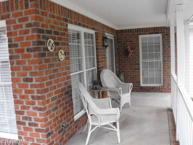 1185 Surry Line Road Pinnacle, NC 27043 - Photo 4 of 8 Other. THE FRONT PORCH IS COMFORTABLE, CHARMING AND DURABLE WITH ITS WRAP AROUND STYLE AND MASONRY / BRICK CONSTRUCTION.
