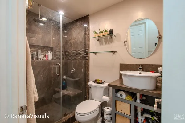 a bathroom with a sink toilet and shower