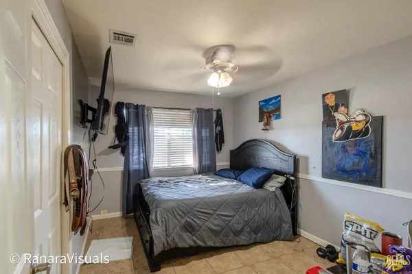 a bedroom with a bed dresser and a window