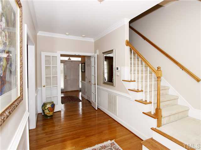 2021 Carrbridge Way Raleigh, NC 27615 - Photo 3 of 25 VIEW OF THE FRONT ENTRANCE FROM THE KITCHEN. NOTICE THE FRENCH DOORS THAT CREATE A TRUE FOYER AND STAIRS AT THE BACK OF THE HOUSE INSTEAD OF AT THE FRONT DOOR.
