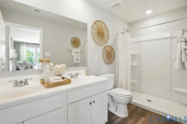 a bathroom with a toilet a sink and a mirror