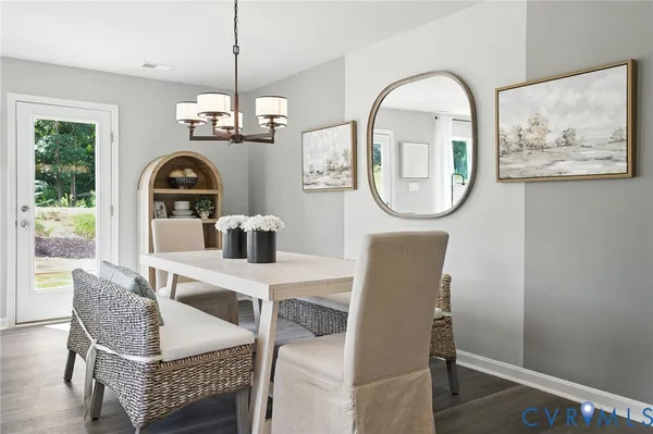 a dining room with furniture a rug and a window