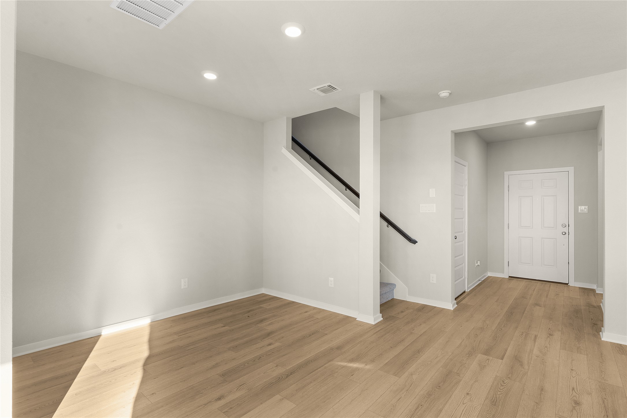 Unfurnished living room with recessed lighting and light wood-type flooring