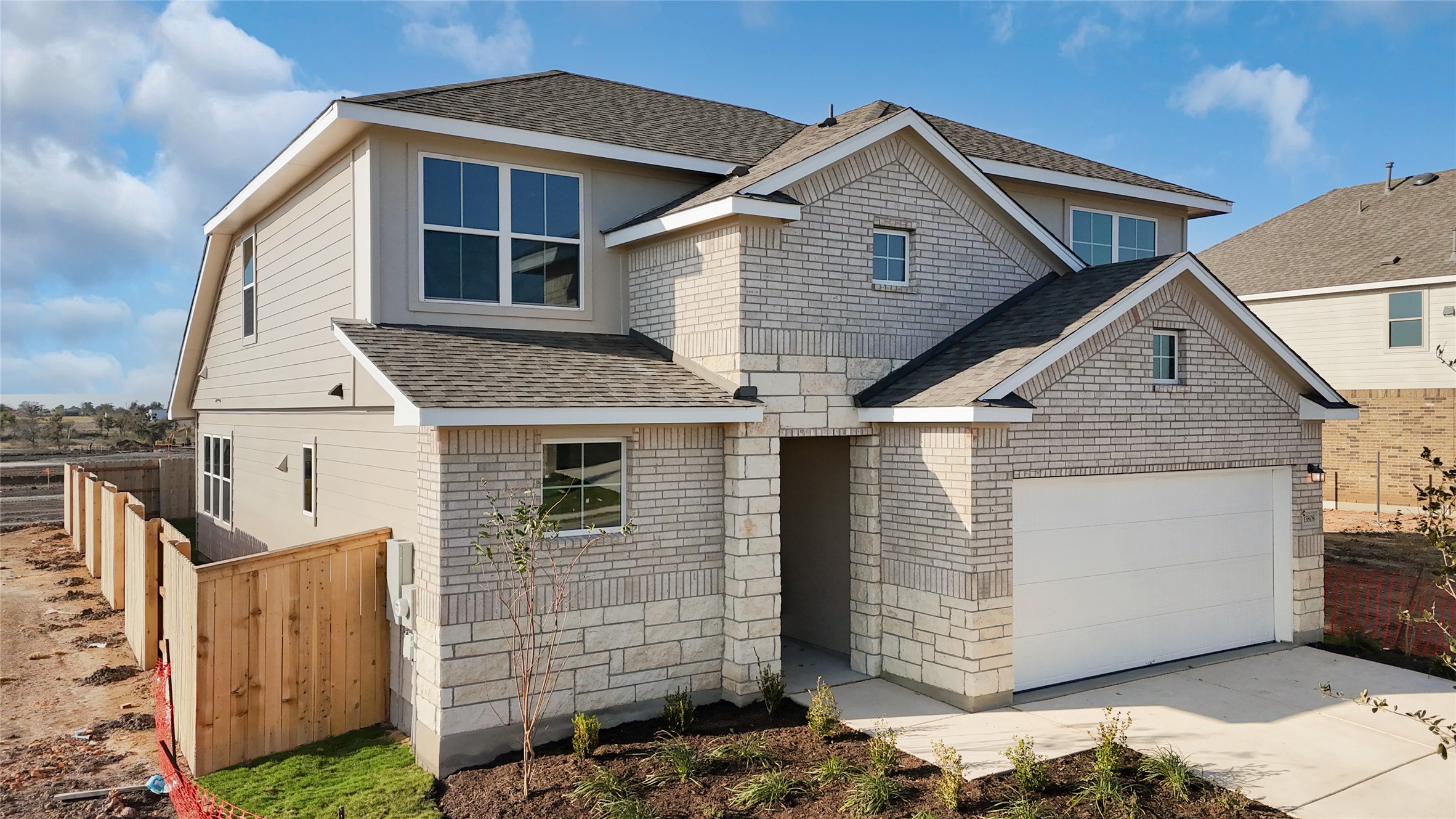 25628 Wheat Seed Lane Elgin, TX 78621 - Photo 17 of 20 View of front of home featuring a shingled roof, concrete driveway, and brick siding