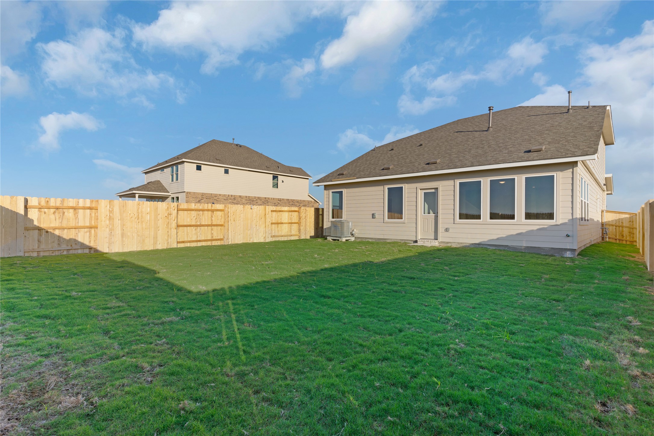25628 Wheat Seed Lane Elgin, TX 78621 - Photo 5 of 20 Rear view of house featuring a fenced backyard