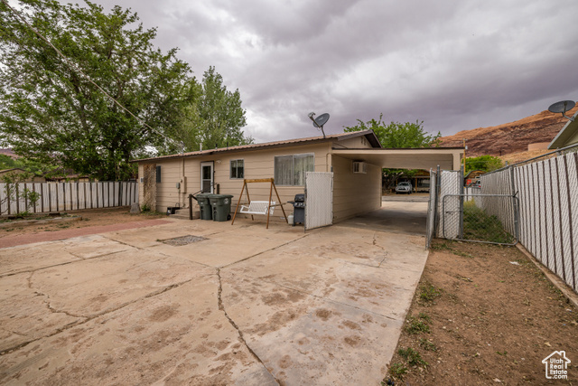527 Palisade Drive Moab, UT 84532 - Photo 19 of 51 Back of property with fence and concrete driveway