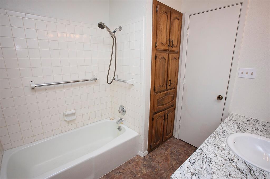 1202 Randy Drive Graham, TX 76450 - Photo 15 of 40 a bathroom with a bathtub and a shower