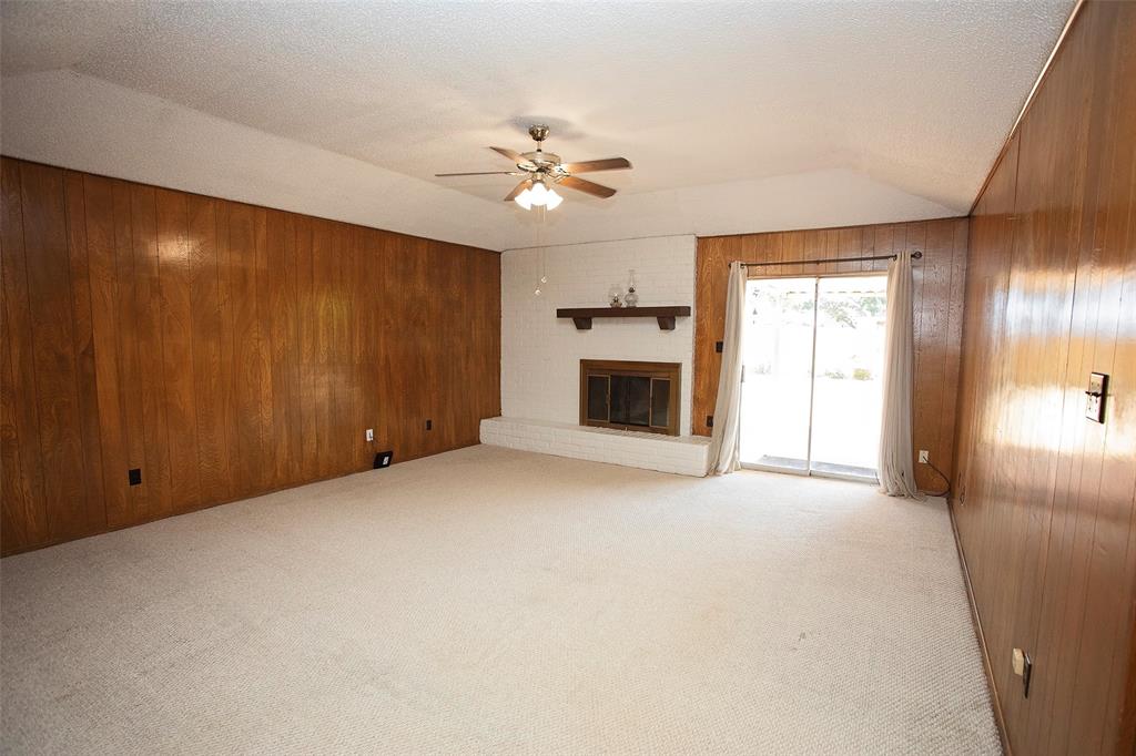 1202 Randy Drive Graham, TX 76450 - Photo 2 of 40 an empty room with windows and fireplace
