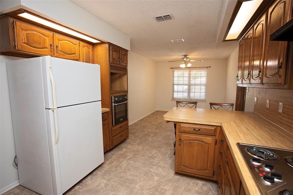 1202 Randy Drive Graham, TX 76450 - Photo 26 of 40 a kitchen with a refrigerator and a sink