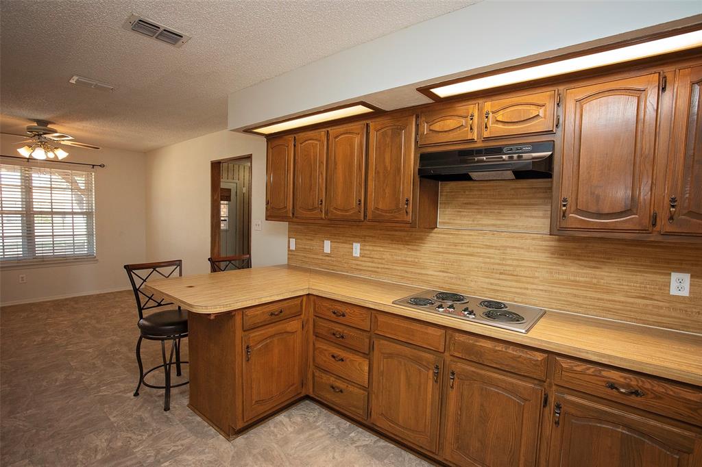 1202 Randy Drive Graham, TX 76450 - Photo 27 of 40 a kitchen with stainless steel appliances granite countertop a sink and cabinets