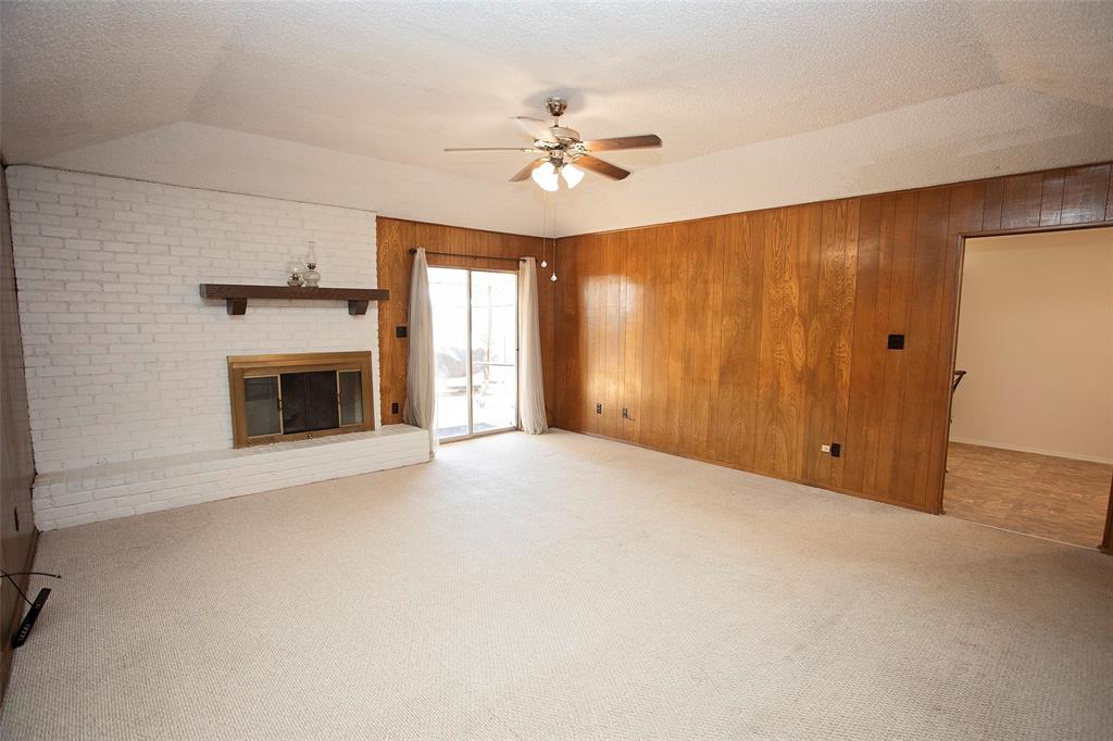 1202 Randy Drive Graham, TX 76450 - Photo 5 of 40 a view of an empty room with a fireplace and a ceiling fan