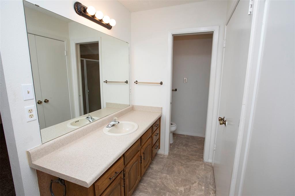 1202 Randy Drive Graham, TX 76450 - Photo 10 of 40 a spacious bathroom with a sink a mirror and a shower