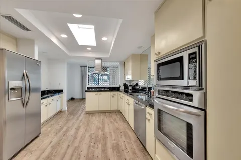 a view of a kitchen with a sink stove and refrigerator