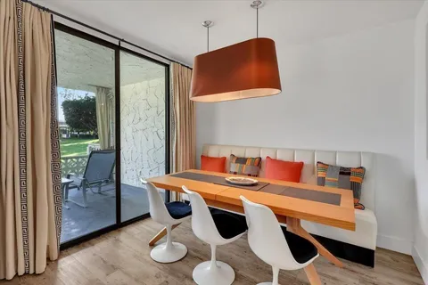 a dining room with furniture and a window