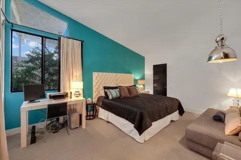 a bedroom with a bed and a desk