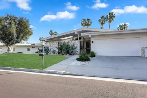 a view of a house with a yard and plants