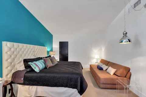 a bedroom with a bed and chair