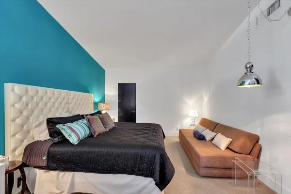 a bedroom with a bed and chair