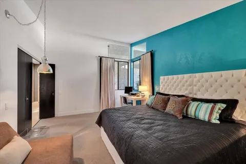 a bedroom with a large bed and a couch