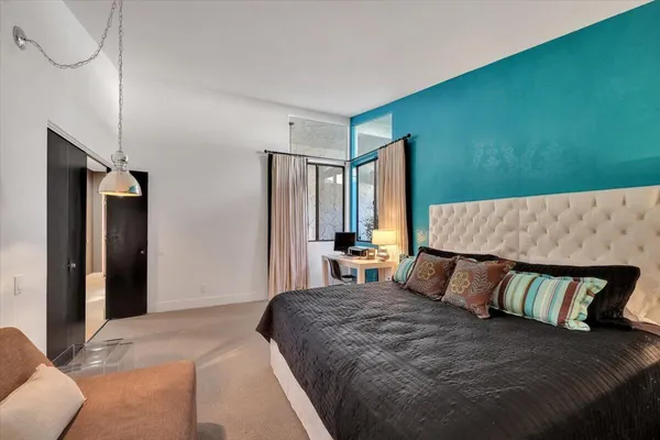 a bedroom with a large bed and a couch