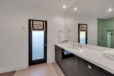 a bathroom with a double vanity sink and a mirror