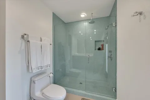 a bathroom with a shower a toilet and sink