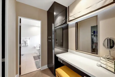 a room with a refrigerator and mirror