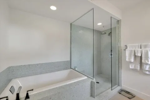 a bathroom with a tub and a shower