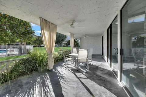 a view of a chair and table in the patio