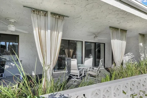 a view of a house with a yard and sitting area