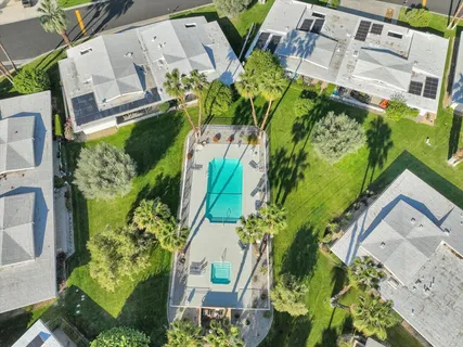 an aerial view of a house with a yard
