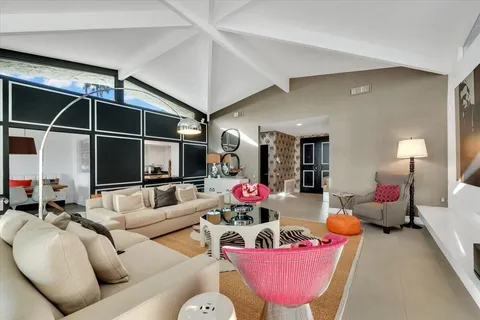 a living room with furniture gym equipment and a flat screen tv