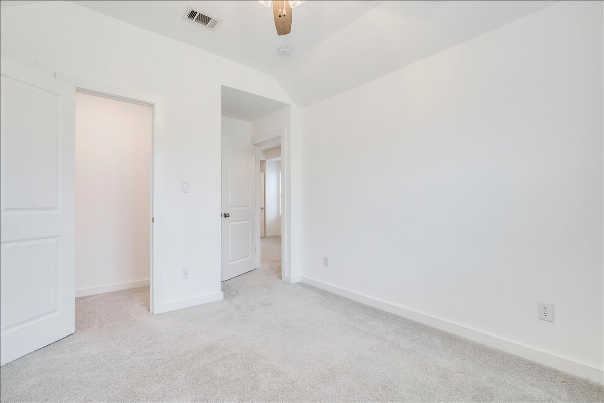 8008 Prairie Rye Drive Lago Vista, TX 78645 - Photo 15 of 40 Room featuring light-toned carpeting, white walls, and white baseboards