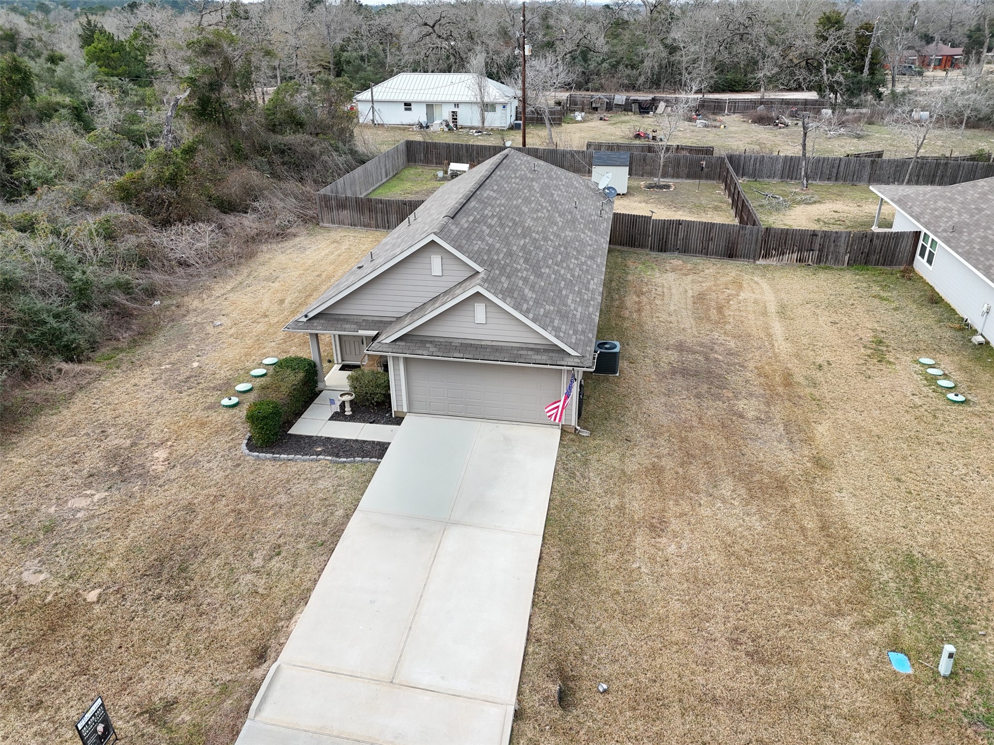26431 Pin Oak Drive Hempstead, TX 77445 - Photo 31 of 32 Elevated aerial view capturing the home’s proximity to nearby residences and natural greenbelt/wooded backdrop.