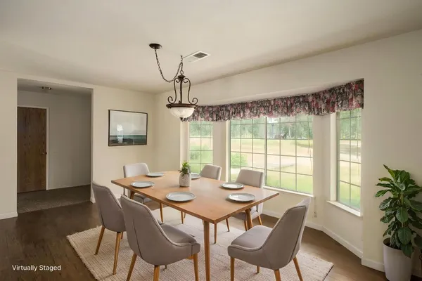 a view of a dining room with furniture window and wooden floor