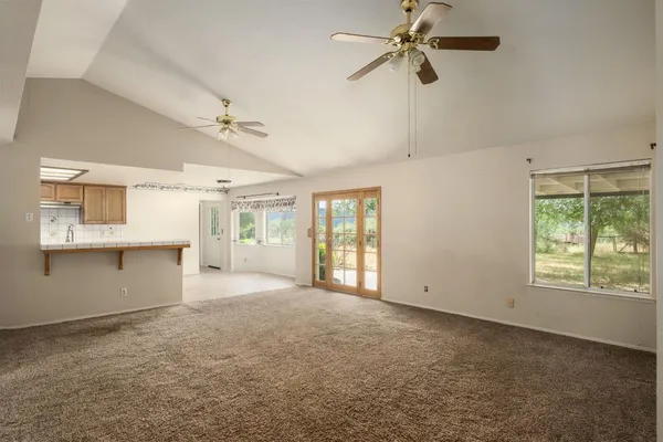 an empty room with windows and entrance