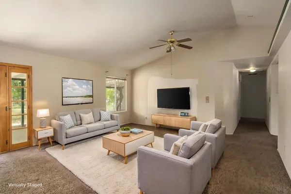 a living room with furniture and a flat screen tv
