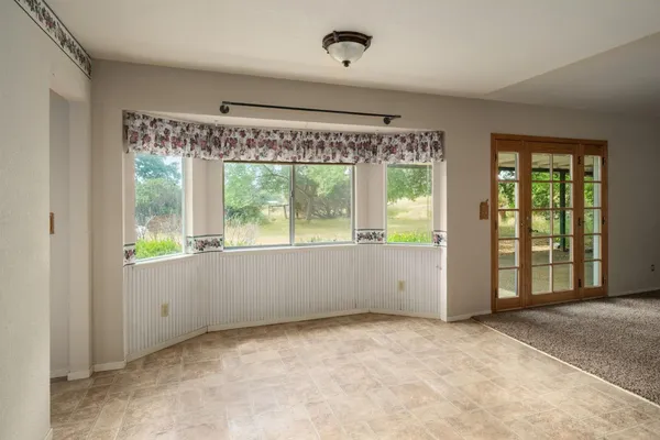 a dining room with furniture a chandelier and wooden floor