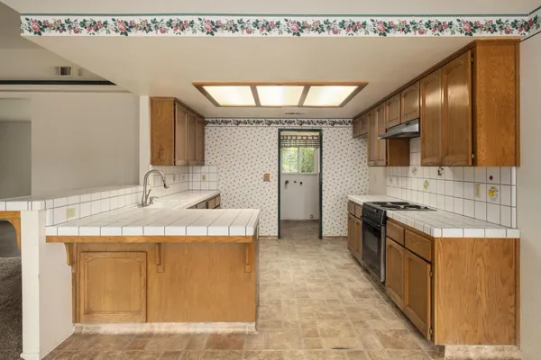 a kitchen with sink cabinets and window