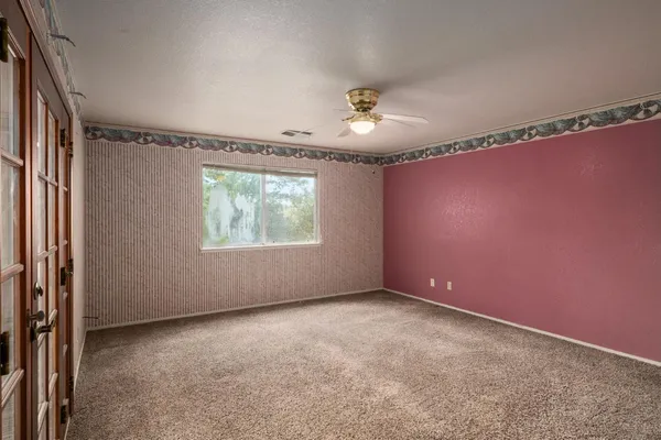 a bedroom with a bed and a window
