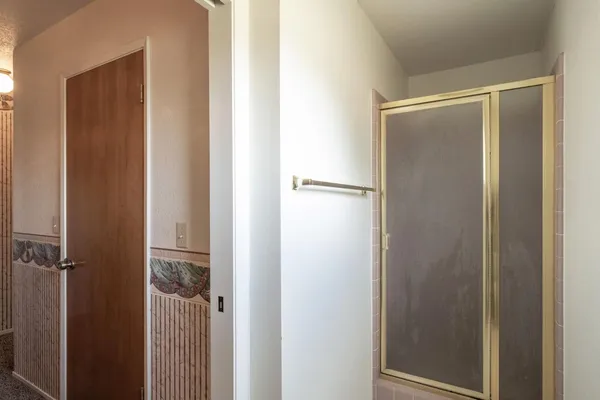 en empty room with windows and fan