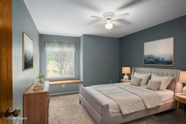 an empty room with windows and fan